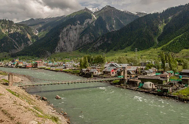 Historic Dawar village on Kishanganga river with suspension footbridge