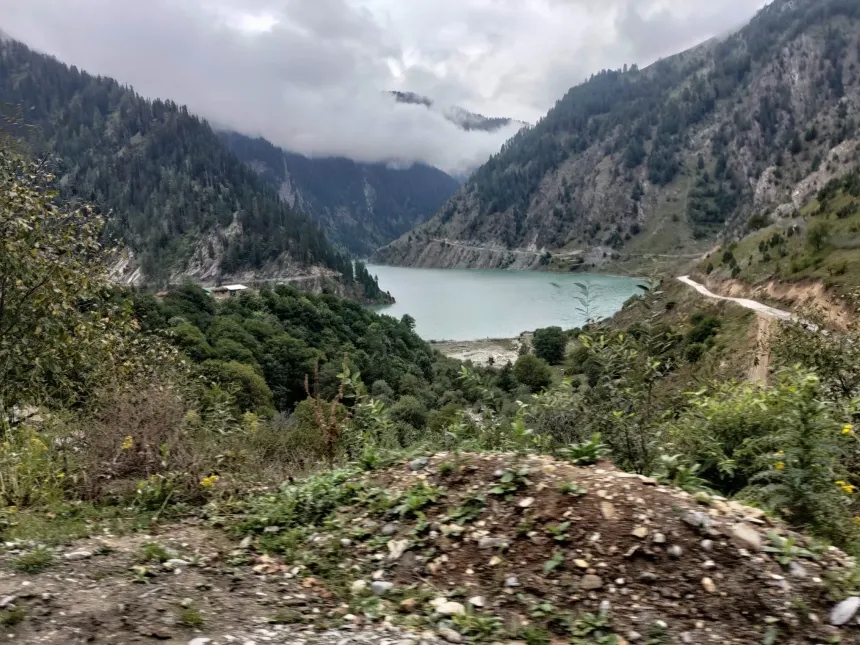 High mountain road view overlooking the turquoise Kishanganga reservoir