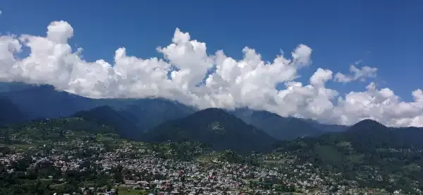 Panoramic wide-angle view of Bhaderwah mountain bowl and cumulus clouds