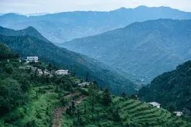 Terraced green mountain slopes and hillside villages of Reasi