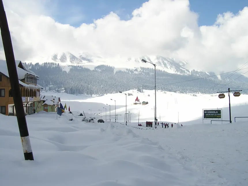 Gulmarg winter snow slopes with alpine chalets and Mt Apharwat Gondola