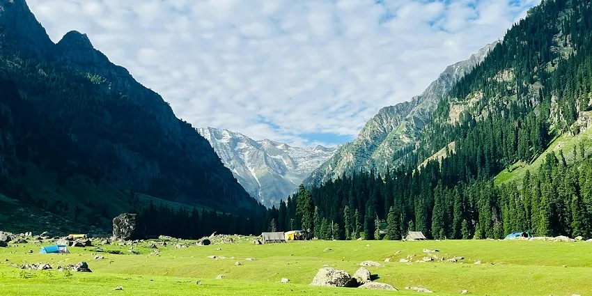 Bungus alpine meadow campsite with trekking tents under towering peaks