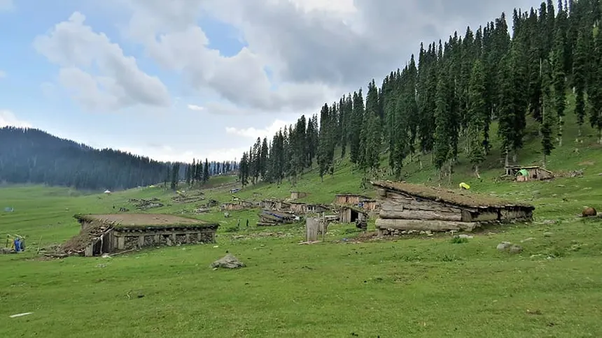 Traditional pastoral log huts on the slopes of Bungus Valley