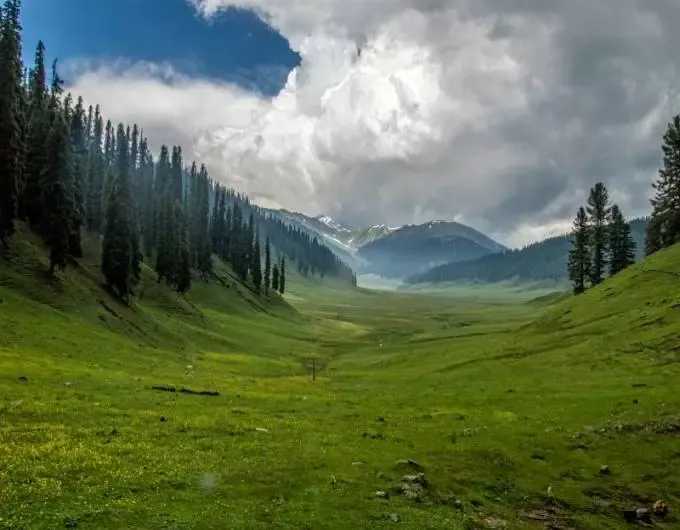 Bungus Valley vast U-shaped green alpine wetland bowl with clouds