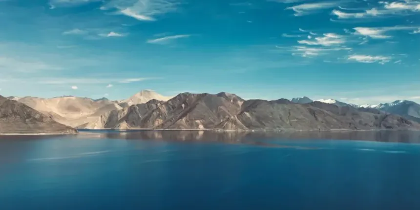 Pangong Tso deep blue mirror waters reflecting barren mountain ridges