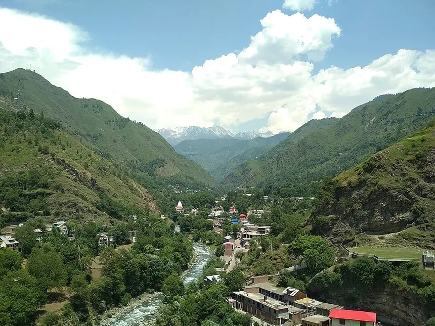 Mandi River valley with temple shrine and green mountain slopes