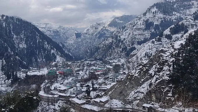Winter snow blanket over Mandi valley village houses and mountains