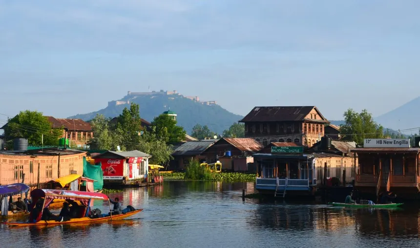 Dal Lake with cedar houseboats and Hari Parbat fort on the ridge