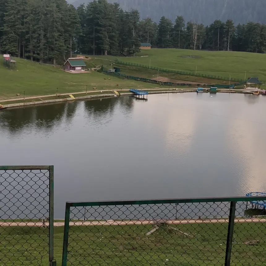 Sanasar Lake green alpine bowl with pine forests and walkway